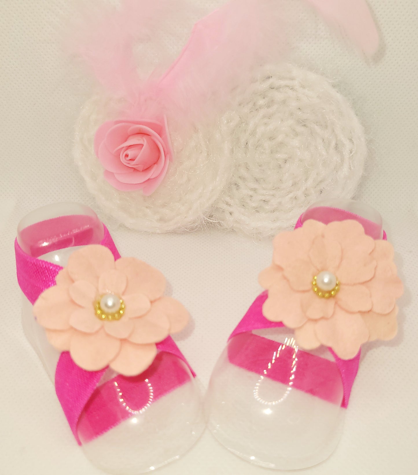 Soft pink and white bow with feathers